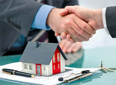 Elmhurst, Ventura CA real estate lawyer shaking hands with client at law firm office.